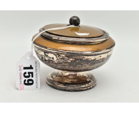 A GEORGE V SILVER LIDDED DISH, a circular form dish on a fluted raised stand, fitted with a removeable lid, yellow plastic de