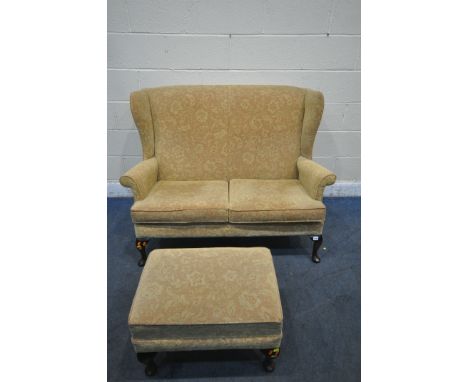 A PARKER KNOLL WING BACK TWO SEATER SOFA, width 136cm x depth 87cm x height 98cm, along with a footstool (condition report: i