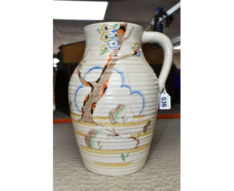 A CLARICE CLIFF SINGLE HANDLED LOTUS JUG, in Tiger Tree pattern, painted with a stylised tree on a cream ground, blue backsta