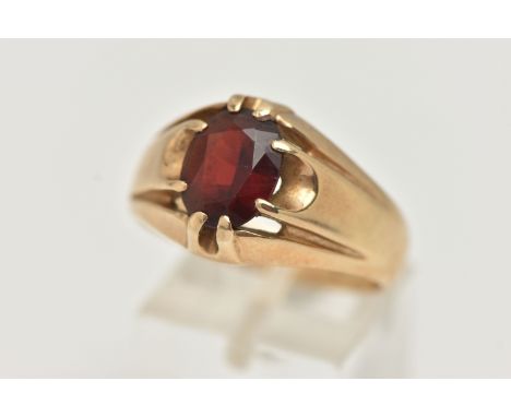 A GENTS 9CT GOLD GARNET RING, gypsy set, oval cut garnet, to a polished band, hallmarked 9ct possibly Sheffield, ring size W 