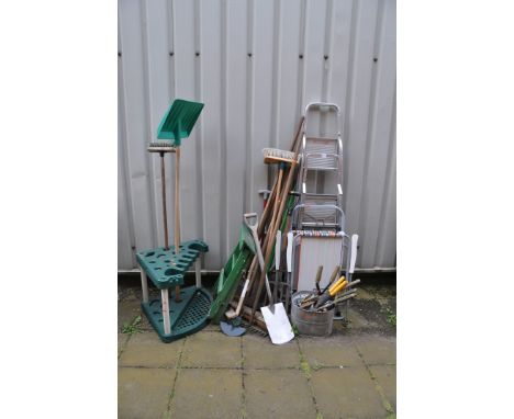 A SELECTION OF GARDEN TOOLS AND EQUIPMENT including two aluminium step ladders, a wooden step ladder, forks, spades, brushes,