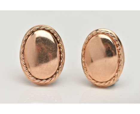 A PAIR OF YELLOW METAL CLIP ON EARRINGS, each of a polished oval form with rope twist surround, measuring approximately lengt