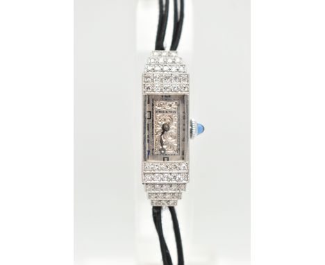 A LADIES DIAMOND SET COCKTAIL WATCH, manual wind watch, rectangular silver scrolling dial, signed 'Thelma', Arabic numerals (
