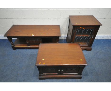 AN OLD CHARM OAK COFFEE TABLE, with a single linenfold door, width 122cm x depth 51cm x height 47cm, a tv stand, and a media 