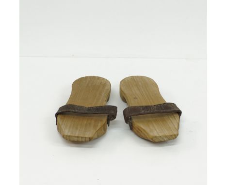 A pair of vintage wooden slippers handmade with leather straps, L26cm, W10cm early 20th century.