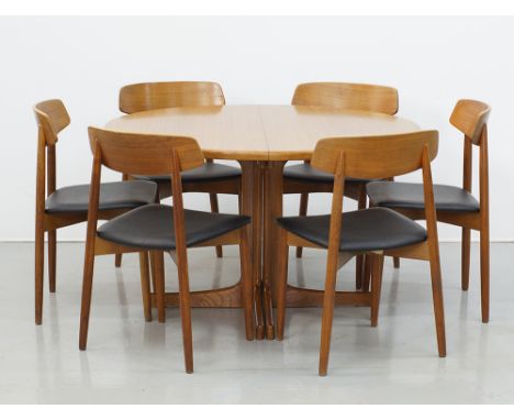 A Scandinavian Modern dining suite comprising a round extendable table designed by Karl Erik Ekselius, the top veneered in te