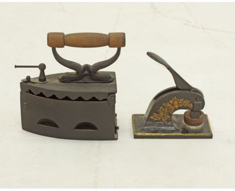 An old cast iron with wooden handle and an antique handpress stamp seal embosser, both heavy and suitable for book ends, earl