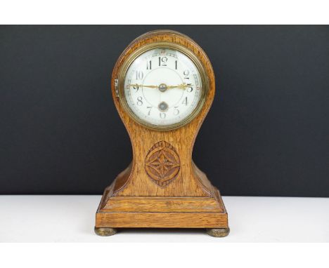 Edwardian balloon oak mantel clock with white enamel dial and carved detail, approx 22.5cm high 
