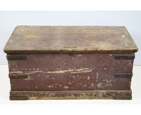 Antique storage trunk having a hinged lid with cast iron banding and lock to front. Measures 106 x 49 x 54cm. 