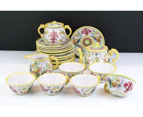 Italian faience tea set with scrolling &amp; floral decoration and yellow border, the lot to include teapot, 6 cups &amp; sau