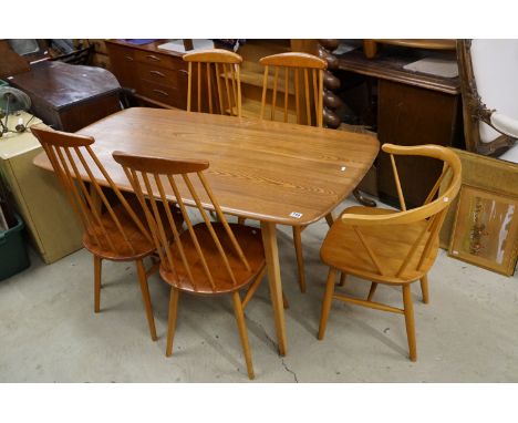 Ercol dining table together with with four Ercol style matching stick back chairs and a carver