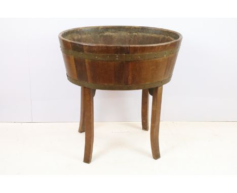 Late 19th / early 20th Century cellarette / planter having brass bindings raised on curved block legs. Measures 77cm tall, 74