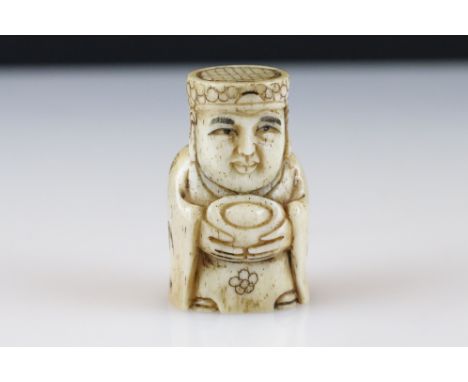 A signed ox bone netsuke of an oriental figure with indigo, approx 5.5cm 