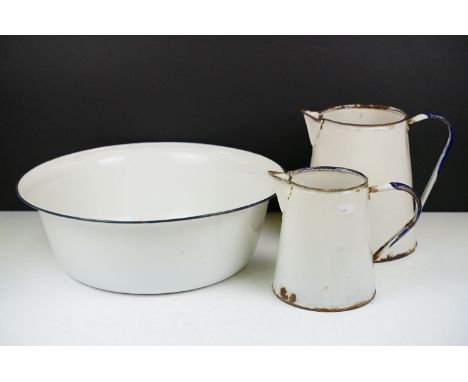 Group of vintage enamel ware to include bowl, two jugs. Bowl measures 39cm diameter. 