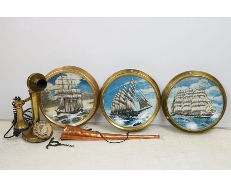 Three glazed brass portholes housing nautical collectors plates, together with a brass candlestick telephone and a copper hun