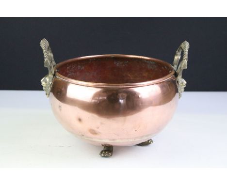 Copper Circular Planter with rolled rim and two brass lion / stag head handles and three lion paw feet, 24cm diameter 