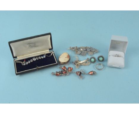 A selection of silver and white metal jewellery including a cameo brooch, stone set earrings, charm bracelet and a moonstone 