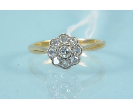 An 18ct platinum set diamond cluster ring, size K, weight approx 2g