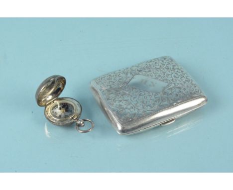 A silver cigarette case with engraved decoration (as found) plus a silver cased compass with engraved monogram to front and d