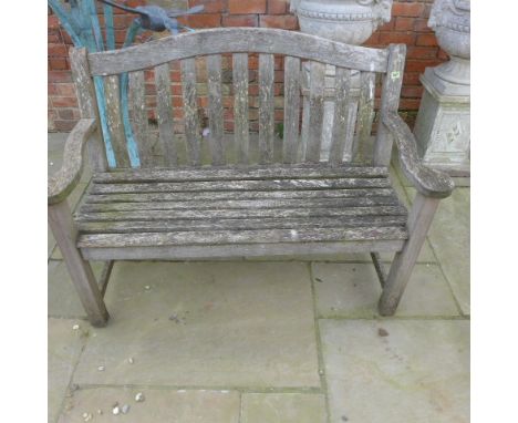 A weathered teak garden bench - Width 130cm 