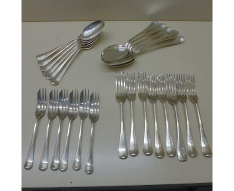 Two sets of six silver spoons, eight silver forks and six silver cake forks, all except two forks hallmarked Sheffield 1926/2