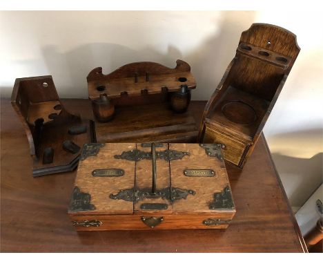 Three pipe racks and a cigar box