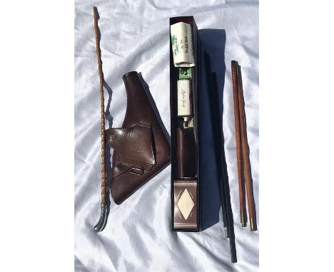 A Parker-Hale gun cleaning set with additional rods, a silver tipped officer’s cane swagger stick and a leather revolver hols