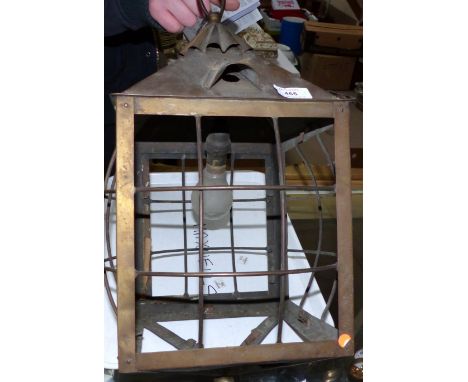 A brass framed hall light with glass panels