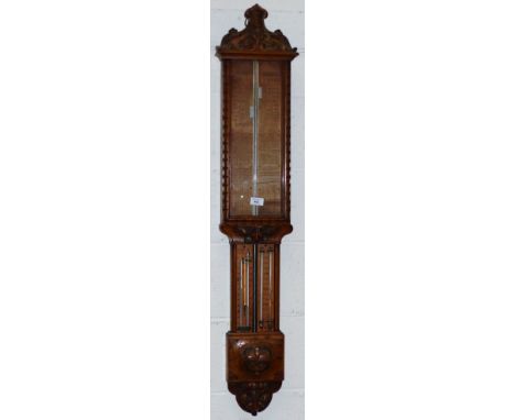 A late 19th century "Admiral Fitzroy" mercury column barometer in carved oak case, with printed scale, Dry & Wet indicator, a