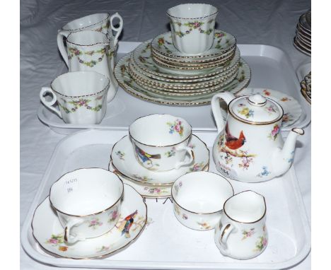 A 1930's Royal Doulton part tea service decorated with exotic birds, 9 pieces, and a similar floral pattern part tea service,