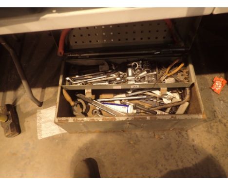 Metal storage chest with inner tray containing selection of car maintenance tools including spanners sockets pliers adjustabl