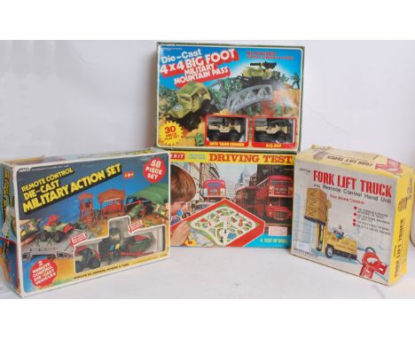 GAMES; A collection of four vintage games; Palitoy Fork Lift Truck, Merit Driving Test, and two Arco diecast sets.