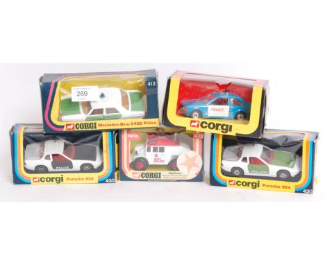 DIECAST: A collection of five vintage boxed corgi diecast police cars - 430 (X2), 297, 240D and 422.