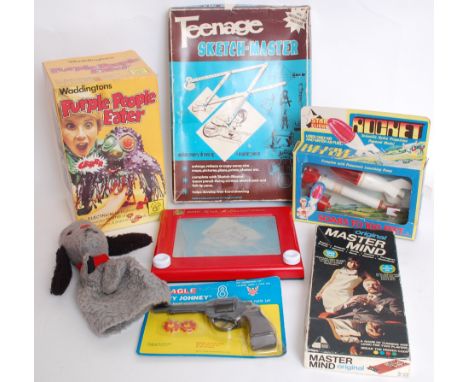 A collection of assorted toys and games to include retro Etch A Sketch, Eadly 'Dirty Johney' cap gun, Waddingtons Puple Peopl