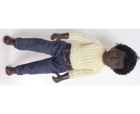 SASHA DOLL; An original vintage 1960's vinyl black Sasha doll, complete with original clothing to include yellow cardigan and