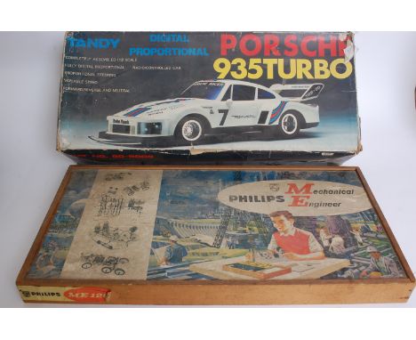 A vintage Phillips Model Engineer game set along with a vintage Tandy Porsche radio controlled car in original box.