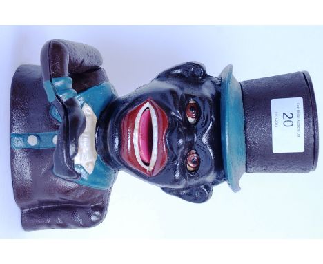 A 20th century cast iron vintage style novelty moneybox in the form of a negro with notation to front
