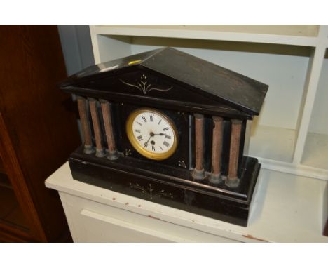 A late Victorian black slate single hole mantel clock of architectural form 
