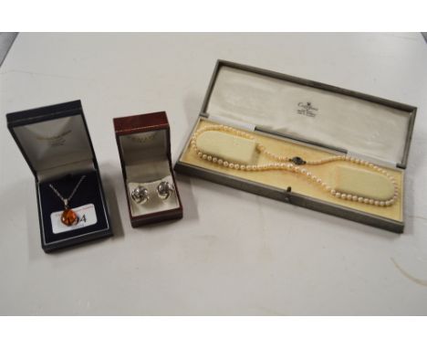 An amber coloured pendant set to a fine link chain; a pair of white metal knot patterned ear-rings; and a pearl necklace