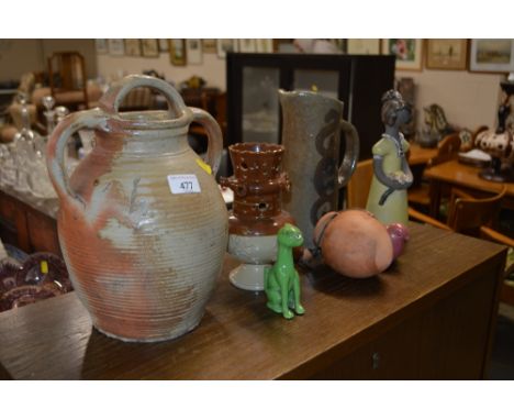 A Studio pottery jug; an earthenware pottery pitcher; a Galle style green glazed cat; a pink lustre decorated model of a bird