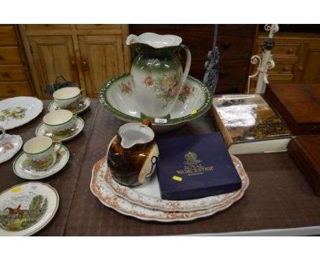 An Edwardian floral decorated wash jug and bowl; two meat plates; a Great Yarmouth pottery jug; and a Royal Worcester commemo