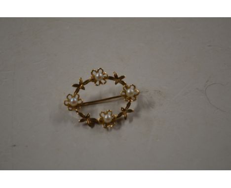 A yellow metal and pearl set oval brooch