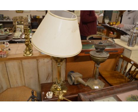 An old brass lamp; an oil lamp and a table lamp