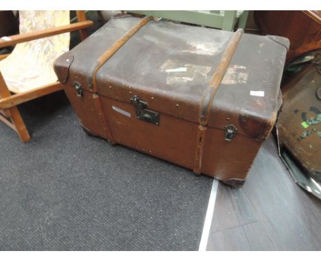A vintage travel trunk bearing shipping labels