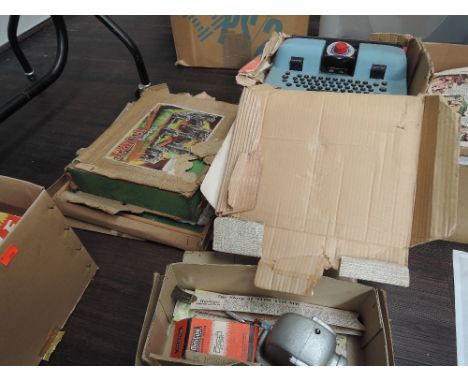 A selection of vintage toys and games including Minicine projector and story book films, Marx de lux typewriter in original b