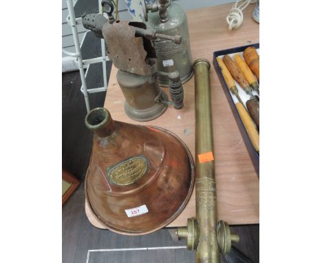A selection of vintage utility and DIY tools including copper and brass washer, brass pump, brass blow torch with grenade sty