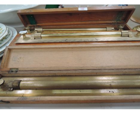 A selection of vintage architectural, design and measuring devices. Including treen boxed solid brass sliding rulers
