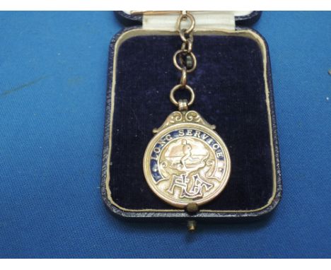 A 9ct gold and enamelled Lincolnshire Football Association Long Service medal having T-bar and small chain inscribed on rever