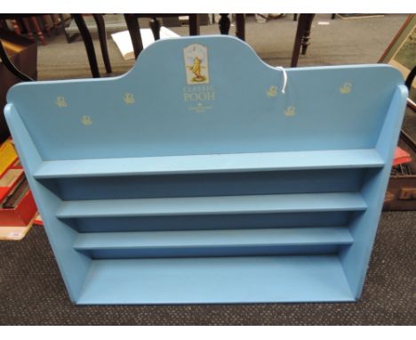 A wooden BFA Classic Pooh display shelf