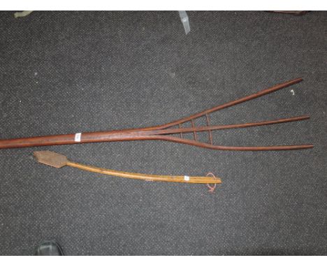 A vintage wooden hay fork and an ethnic art wooden back scratcher  